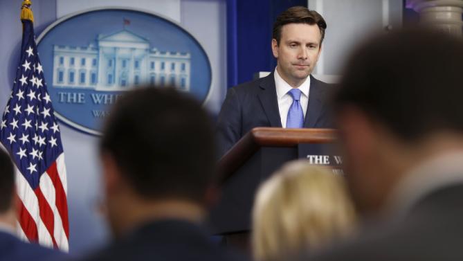 Earnest answers questions about an apparent bomb threat after evacuated journalists returned to the press briefing room at the White House in Washington