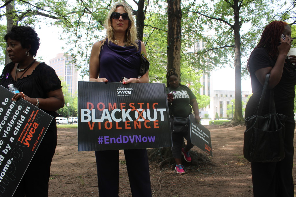 A protester holds a sign at the Black Out Domestic Violence rally on May 10, held by the YWCA. (Ariel Worthy/ Birmingham Times)