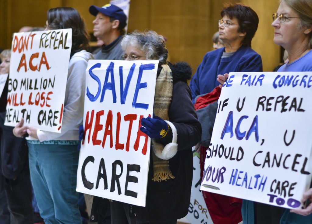 People attend a health care rally at the Indiana Statehouse in support of the Affordable Care Act, Sunday, Jan. 15, 2017, in Indianapolis. President-elect Donald Trump has vowed to overturn and replace the Affordable Care Act, and majority Republicans in Congress this week began the process of repealing it using a budget maneuver that requires a bare majority in the Senate. (Austen Leake, The Tribune-Star via AP)