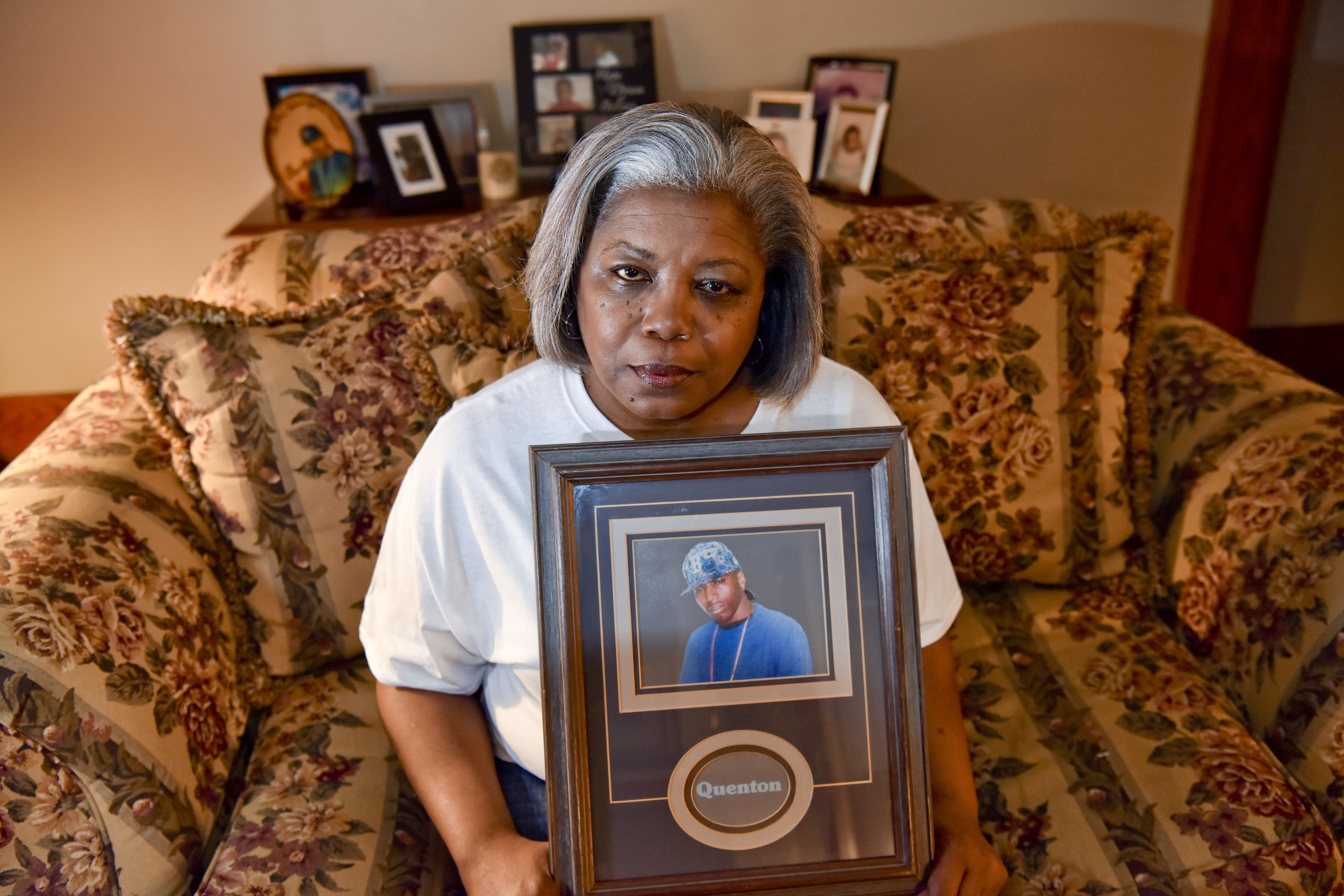 Kim Washington holds a picture of her son Quenton that she often carries with her when she shares her story of losing Quenton to violence. (Frank Couch / The Birmingham Times)