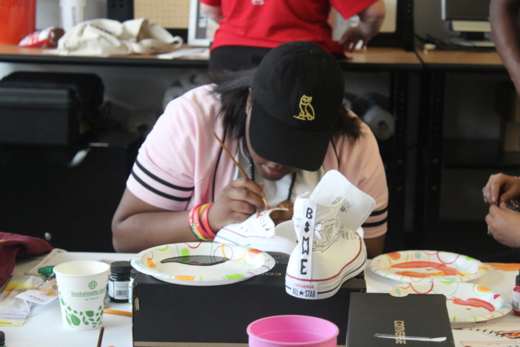 Yeldray Perkins works on her design for Chucks & Tux. Perkins said her design inspiration was Africa. Both of her parents are from West Africa. (Ariel Worthy, The Birmingham Times)