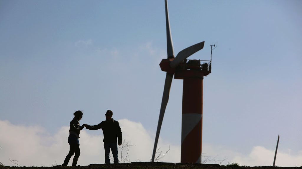 An Israeli couple visits the wind farm on Mount Bnei Rasan overlooking the border with Syria on Nov. 27, 2009, in the Golan Heights. The 10 wind turbines produce 6 megawatts of electricity which is used by local industry and the residents of the disputed plateau that Israel captured from Syria in the 1967 Six Day War. (David Silverman/Getty Images)