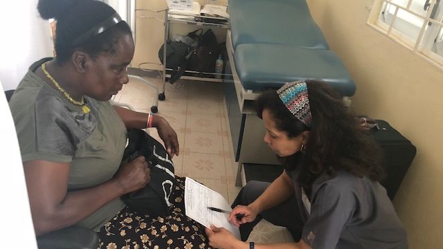 While on a medical mission in St. Mary's Parish in Jamaica, Dr. Theresa Buckson (right) chats with a patient to assess her medical history. (Courtesy of Dr. Theresa Buckson)