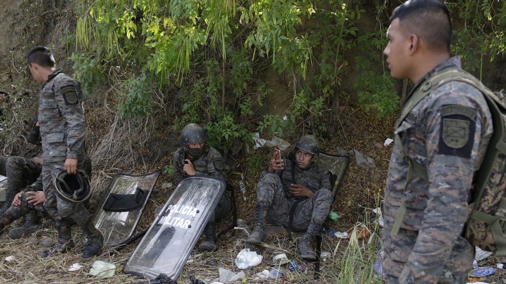 Guatemalan military officers rest in El Florido, Guatemala. The nations' violent history included episodes with government, military, religious, and political forces, often linked to ideological power struggles derived from the Cold War and its aftermath. (Photo by Josue Decavele/Getty Images)