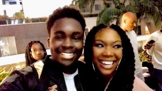 Ozie Nzeribe enjoys a laugh with actress/model/singer Brandy Norwood, whose younger brother, Ray J Norwood, helped a 13-year-old Nzeribe record his first song. (Courtesy Randi Cone/Interdependence Public Relations)
