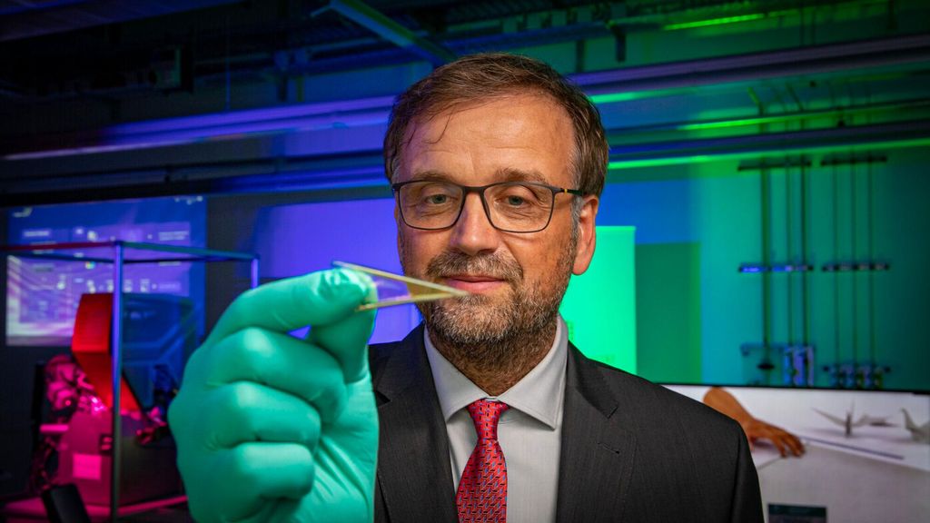 Oliver G. Schmidt is seen holding flexible microelectronics that can be fitted with many of the tiny batteries he and his research team helped develop. (Jacob Muller/Zenger)