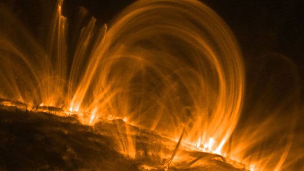 Coronal loops, emerging from the Sun's surface, are captured in an image from the Transition Region and Coronal Explorer Spacecraft. TRACE was the third spacecraft in NASA's Small Explorer program and last transmitted to Earth in 2010. According to a new study, at least some of the coronal loops captured in images may just be optical illusions. (NASA/TRACE)