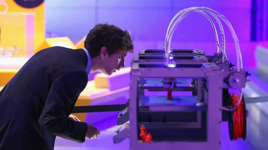A technician checks on a 3D printer as it constructs a model human figure in the exhibition '3D: printing the future' in the Science Museum on October 8, 2013 in London, England. The exhibition, which opens to the public tomorrow, features over 600 3D printed objects ranging from: replacement organs, artworks, aircraft parts and a handgun. (Photo by Oli Scarff/Getty Images)