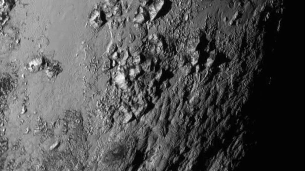 In this handout provided by NASA, a close-up image of a region near Pluto's equator shows a range of mountains rising as high as 11,000 feet (3,500 meters) taken by NASA's New Horizons spacecraft as it passed within 7,800 feet of the dwarf planet on July 14, 2015. The probe was launched Jan. 19, 2006, aboard an Atlas V rocket from Cape Canaveral, Florida. (NASA/APL/SwRI via Getty Images)