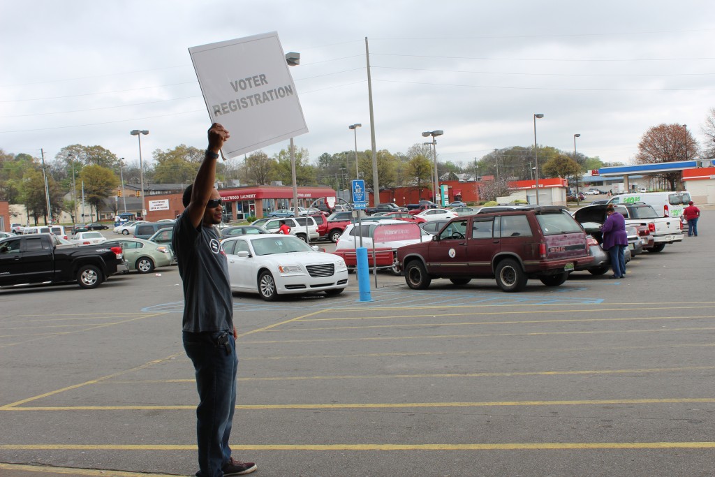 BULYP member Tamir Buford stands outside Winn Dixie in Five Points West to point the direction for voter registration 