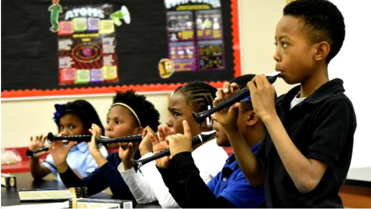 Robinson Elementary School, teaching third-graders to play the flutophone (Solomon Crenshaw Jr. Photos: Special to the Times)