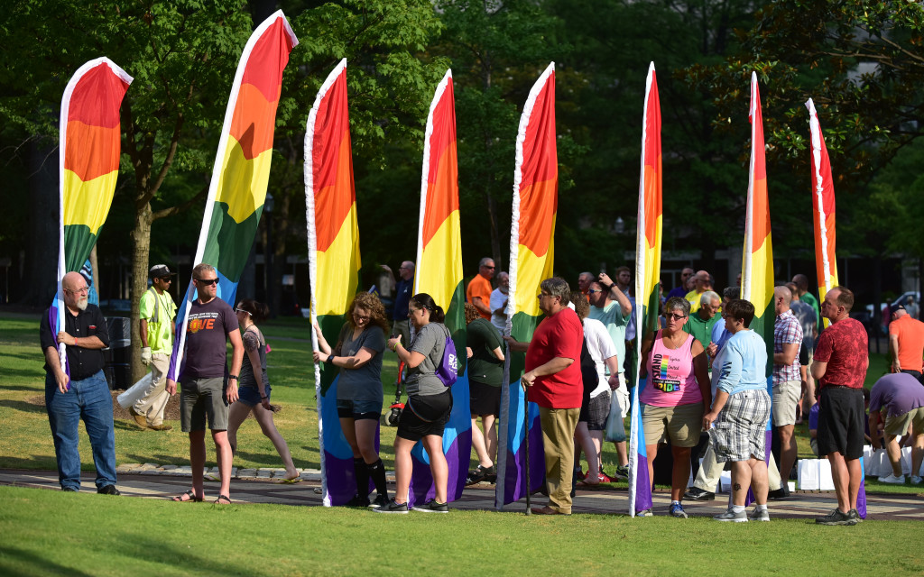 Flag bearers line up in Linn Park as the ceremony begins. Central Alabama Pride held a remembrance and candle light vigil for those killed and injured in an Orlando, Florida nightclub. The names of the victims were read aloud on the steps of the Jefferson County Courthouse and a rainbow banner was draped over the Birmingham City Hall entrance.  (Frank Couch / The Birmingham Times)