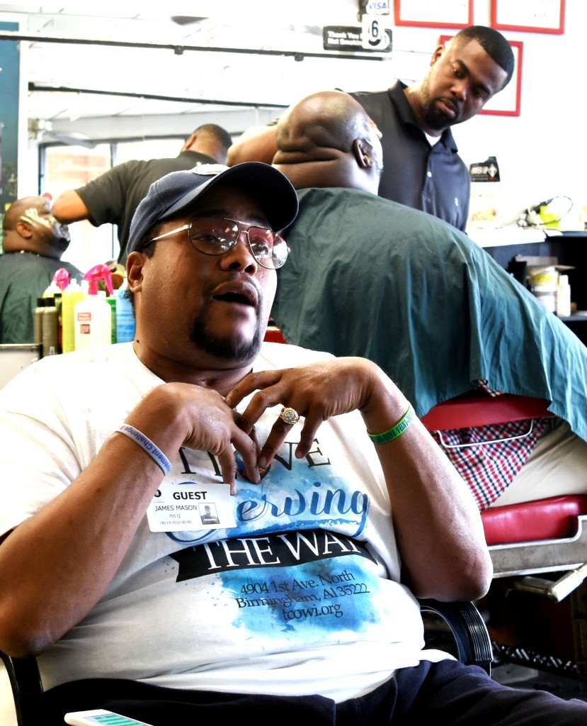 The Rev. James Mason talks as a patron gets a shave from shop owner Jimmy Shallow. (SOLOMON CRENSHAW JR. PHOTOS, FOR THE BIRMINGHAM TIMES)