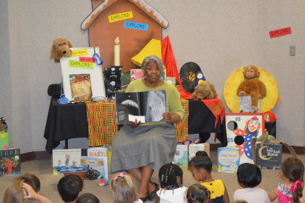 Cassandra Scott, aka Avondale Regional Library Storyteller Ms. Cas, reads to children during a program at Southside Library.