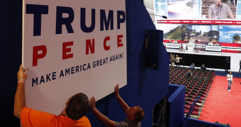 Workers place a sign as they prepare at Quicken Loans Arena for the Republican National Convention, Sunday, July 17, 2016, in Cleveland. (AP Photo/Carolyn Kaster