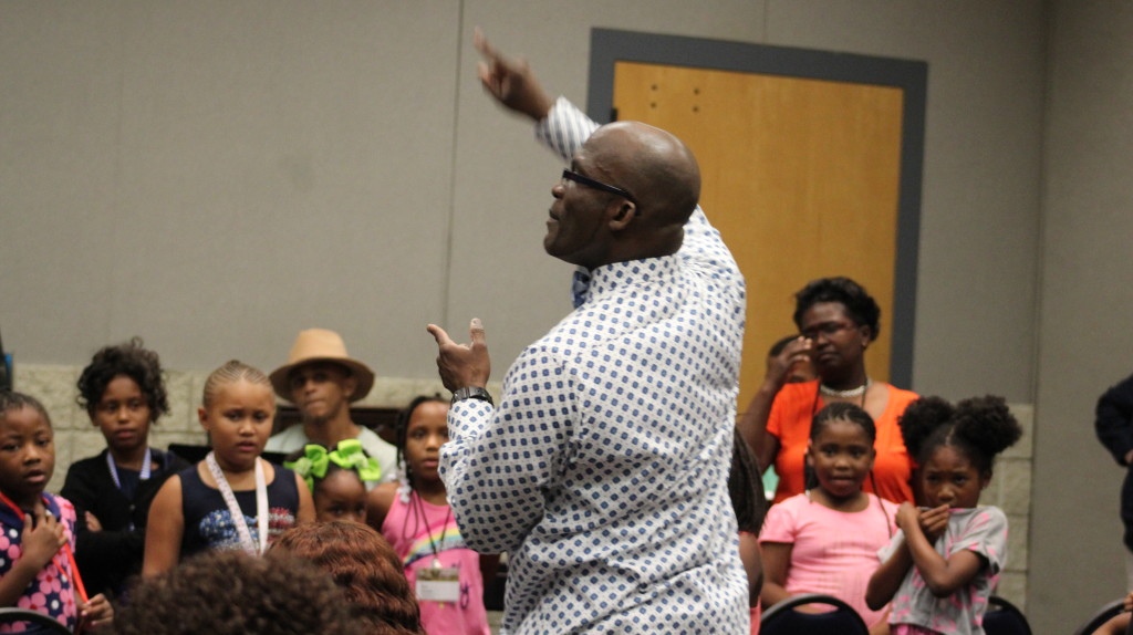 Hugh Davis teaches the children of the GMWA conference the song "God Made Me." (Ariel Worthy, The Birmingham Times)