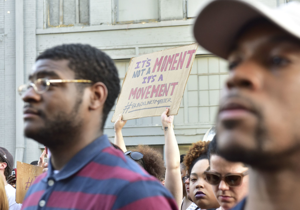 Protesters hold signs up at a brief rally in front of the Birmingham Police Headquarters. A solidarity protest and march held at Kelly Ingram Park saw hundreds of people listen to speakers, chant and march to Birmingham Police Headquarters. (Frank Couch / The Birmingham Times)