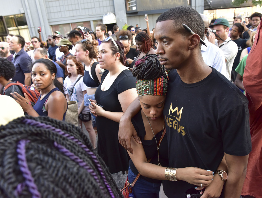 Brittany Powell hugs Brad Harper during a rally in front of Birmingham Police Headquarters. A solidarity protest and march held at Kelly Ingram Park saw hundreds of people listen to speakers, chant and march to Birmingham Police Headquarters. (Frank Couch / The Birmingham Times)