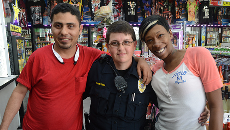 Officer Heather Campbell (center) with Waleed Senan, left, and Crystal Phillips at the Ensley Shell. (Karim Shamsi-Basha, Alabama NewsCenter)