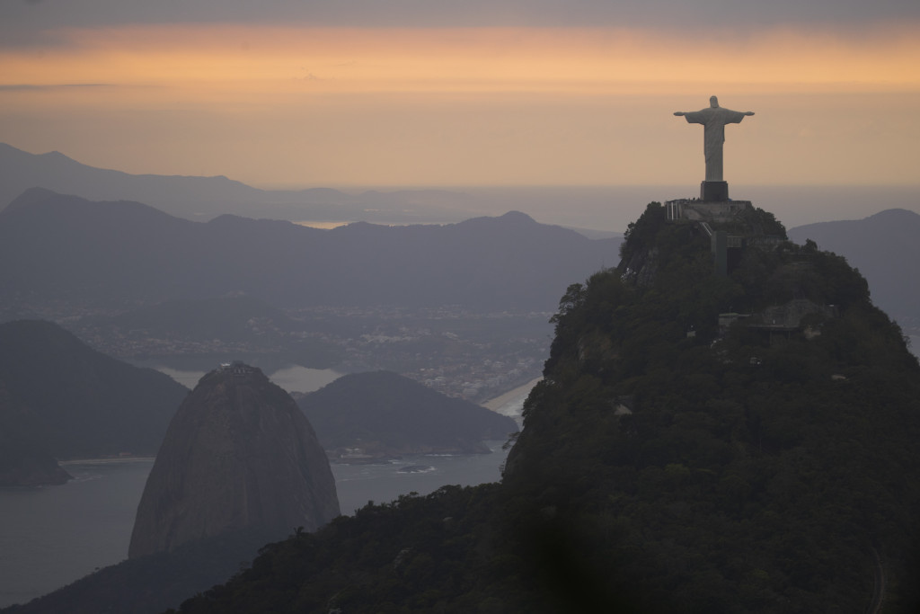 The Christ the Redeemer statue and Sugar Loaf mountain stand as the sun rises in Rio de Janeiro, Brazil, Thursday, Aug. 4, 2016. The 2016 Summer Olympics is scheduled to open Aug. 5. (AP Photo/Felipe Dana)