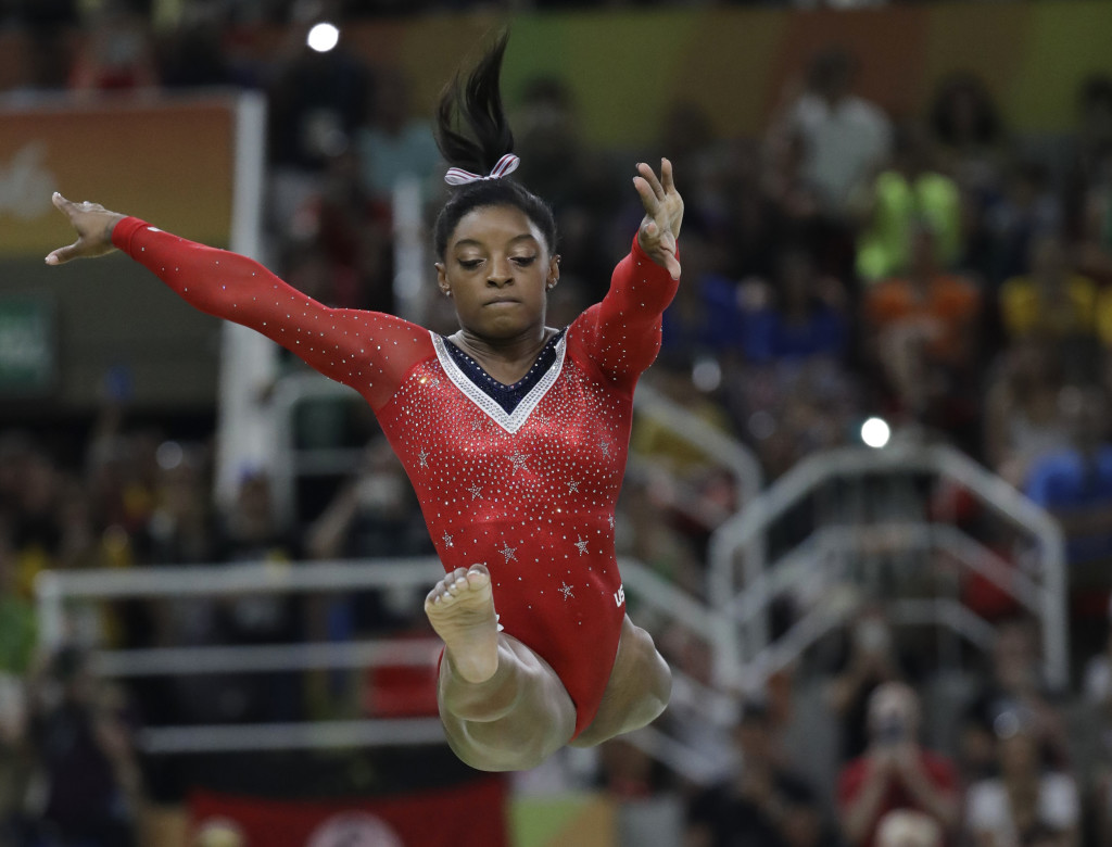 United States' Simone Biles performs on the balance beam during the artistic gymnastics women's apparatus final at the 2016 Summer Olympics in Rio de Janeiro, Brazil, Monday, Aug. 15, 2016. (Julio Cortez, The Associated Press)