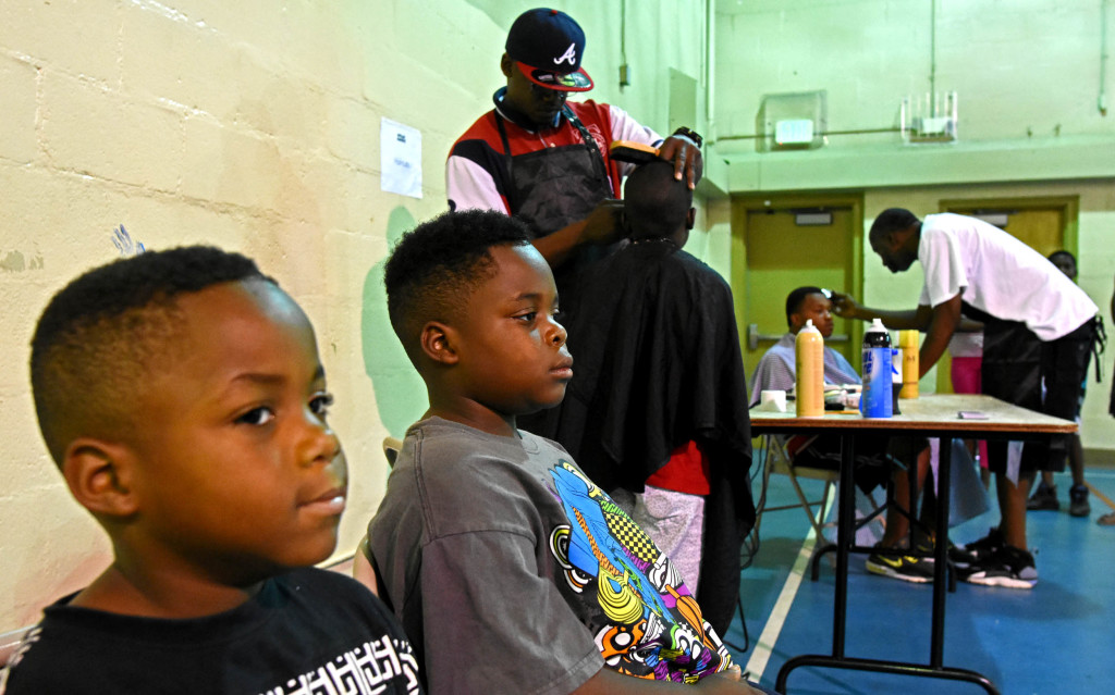 Brothers Jaylin and Aaron Caver wait for their cuts. (Solomon Crenshaw Jr photos, for The Birmingham Times)