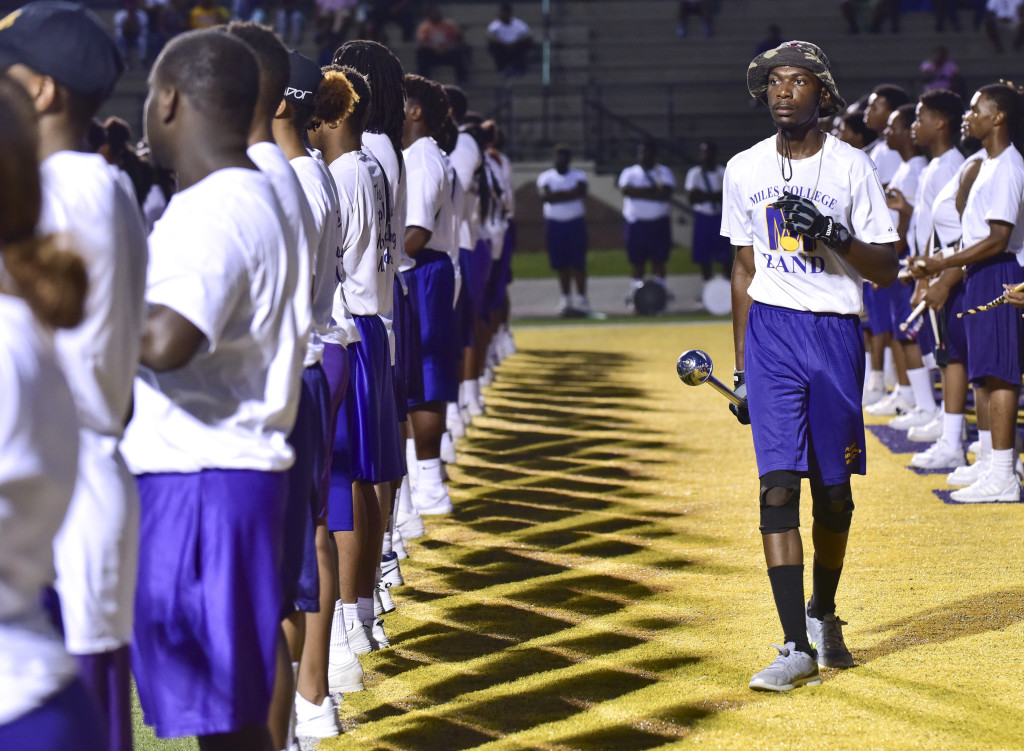 Head Drum Major Justin Mims helps line up band members in a recent Miles College Purple Marching Machine Band practice in Fairfield. (Frank Couch photos, The Birmingham Times)