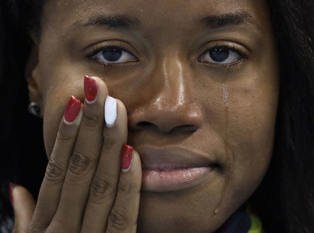 United States' gold medal winner Simone Manuel cries during the medal ceremony for the women's 100-meter freestyle final during the swimming competitions at the 206 Summer Olympics, Aug. 12, in Rio de Janeiro, Brazil. (Michael Sohn, The Associated Press)