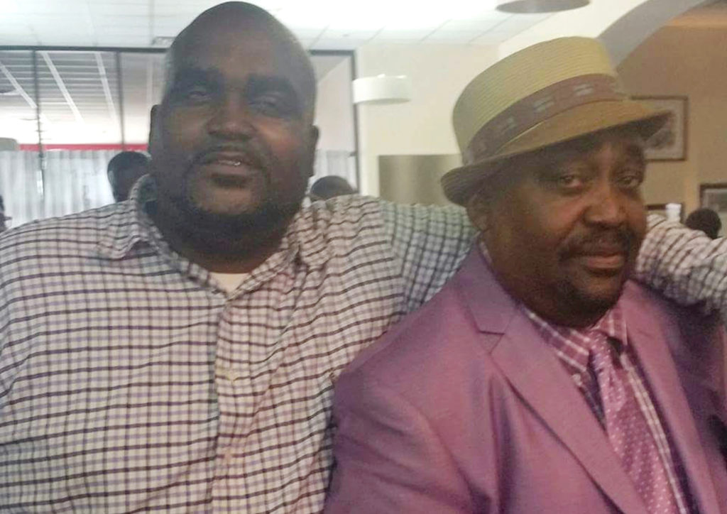This undated photo provided by the Parks & Crump, LLC shows Terence Crutcher, left, with his father, Joey Crutcher. Crutcher, an unarmed black man was killed by a white Oklahoma officer Friday, Sept. 16, 2016, who was responding to a stalled vehicle. (Courtesy of Crutcher Family/Parks &; Crump, LLC via AP)