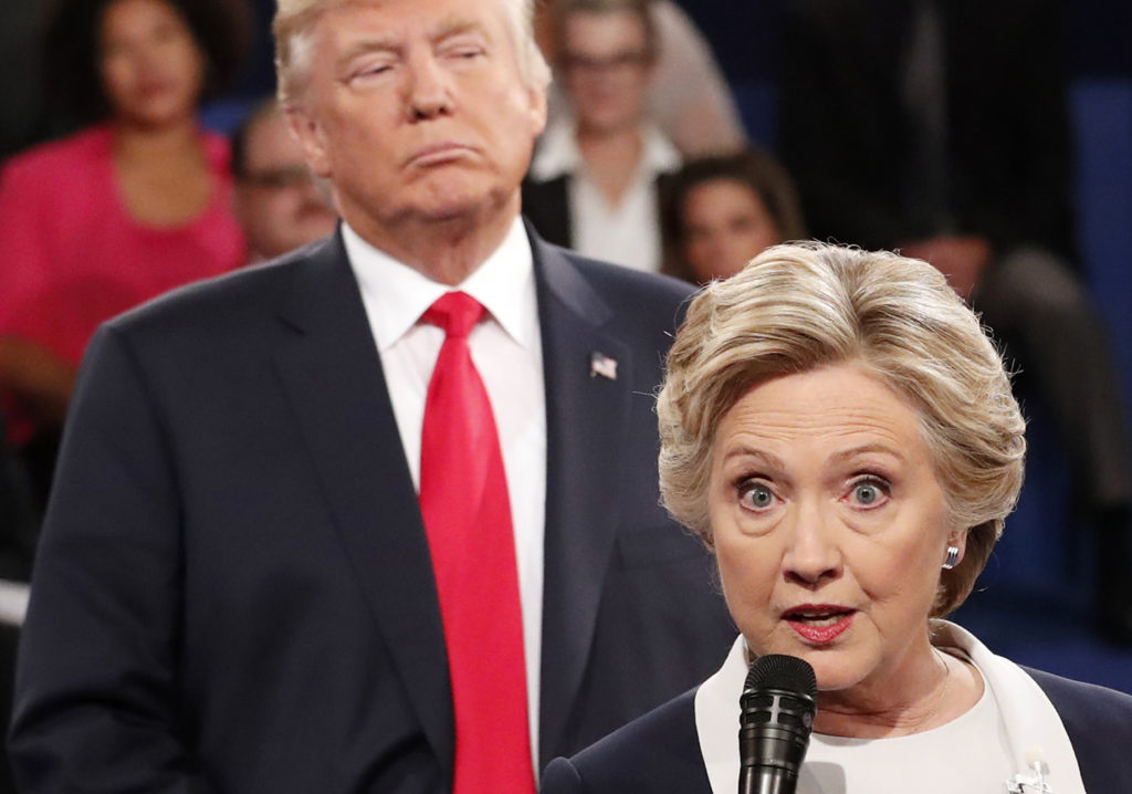 Democratic presidential nominee Hillary Clinton, right, speaks as Republican presidential nominee Donald Trump listens during the second presidential debate at Washington University in St. Louis, Sunday, Oct. 9, 2016. (Rick T. Wilking/Pool via AP)