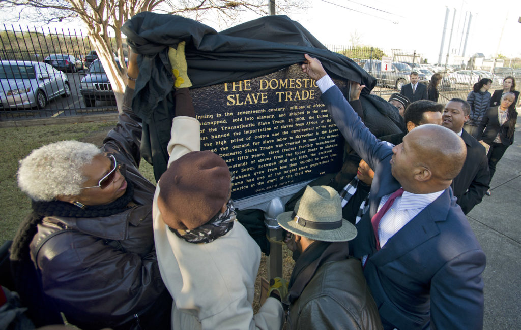 Bryan Stephenson, founder and executive director of the Montgomery-based Equal Justice Initiative, right, helps unveil a historical marker honoring the Domestic Slave Trade. (Bernard Troncale,special to The Times)