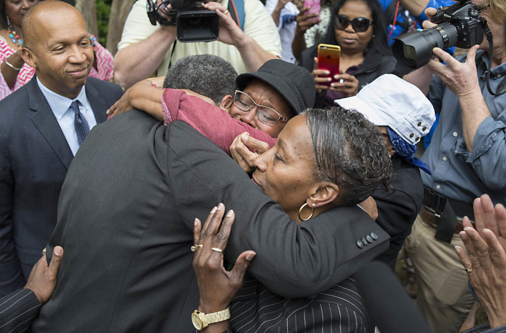 Members of the committee hug after the unveiling of a historical marker honoring the Domestic Slave Trade. (Bernard Troncale, special to The Times)
