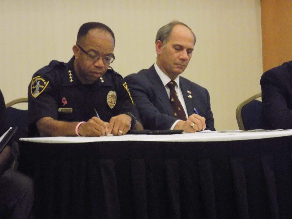 Birmingham Police Chief A.C. Roper (left) and Roger Stanton (right) take notes during the panel. (Monique Jones, The Birmingham Times)