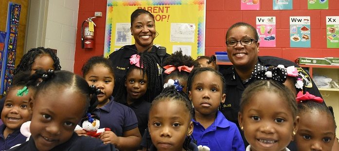 Girl Power is on display as Sergeant Reva Palmer and Officer Nicole Collins pose with some of the girls of Hemphill. (Solomon Crenshaw Jr., special to The Times)