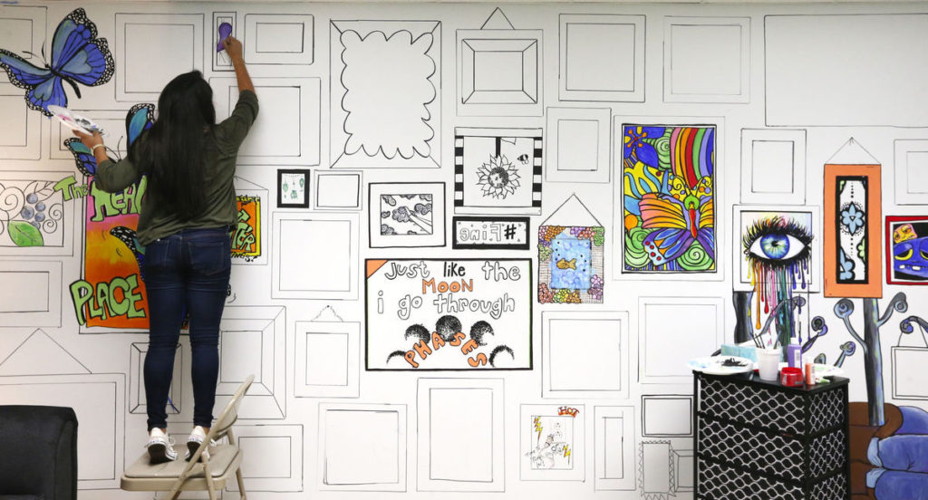 Gracey Weatherford paints a mural in Muscle Shoals at the Healing Place. The Healing Place renovated their attic to be a place for teens to meet up. Allison Carter, Times Daily