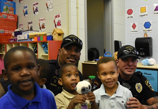 Officers Larry Foster (left) and Todd Sutherland visit with Hemphill students Jacoby Woodgett-Davis, Deon Cunningham-Buchannon and Hillman Tubbs. (Solomon Crenshaw Jr., special to The Times)