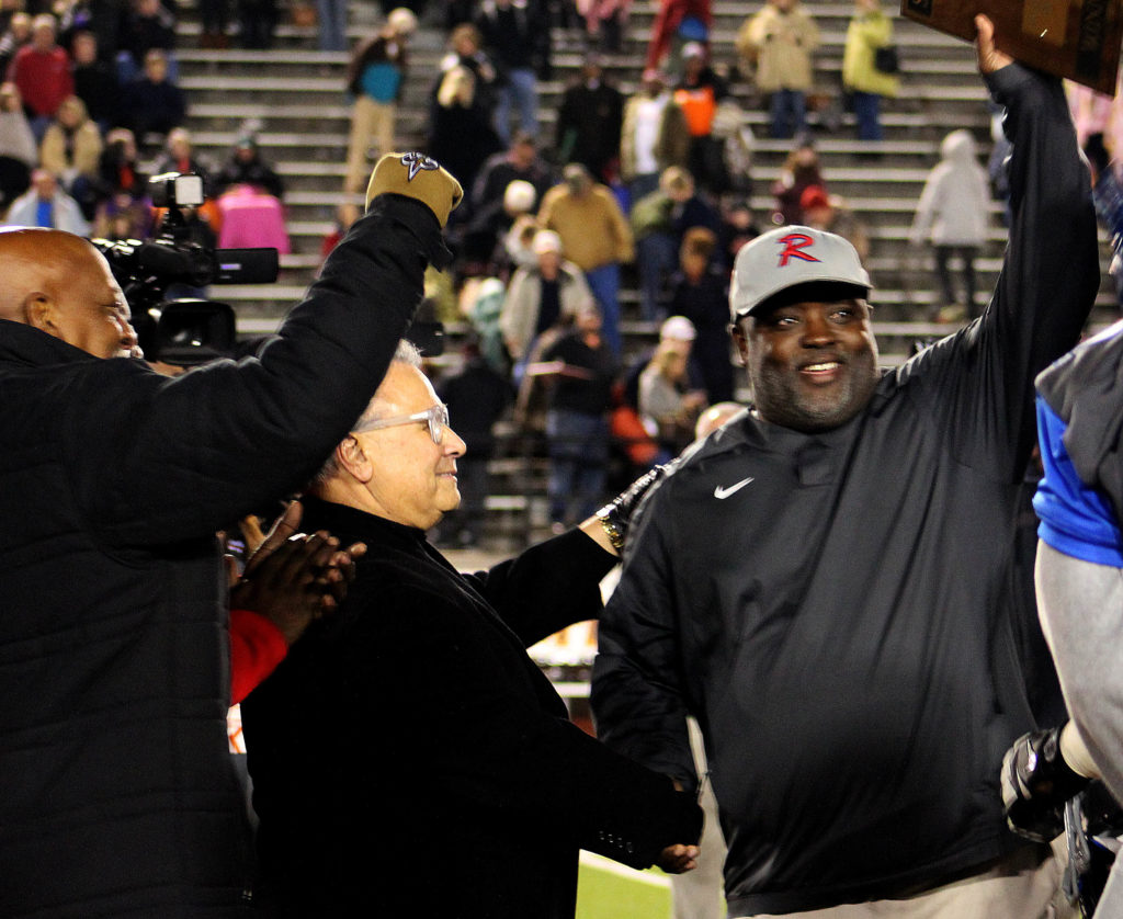 State Sen. Rodger Smitherman, D-Birmingham, and interim Birmingham School Superintendent Larry Contri congratulate Ramsay coach Reuben Nelson after his Rams beat Austin 24-14 to win their Class 6A Alabama High School Athletic Association semifinal on Friday, Nov. 25, 2016. Ramsay joins Wenonah as the first two Birmingham City Schools to advance to state football championship games in the same post season. (Fransetta Henry, special to The Birmingham Times)