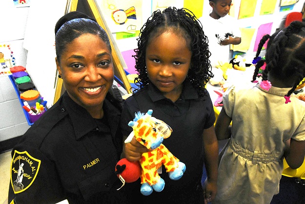 Sergeant Reva Palmer shares a smile with Valencia Dowdell. The Birmingham Police Department (BPD) is part of a select group of pilot cities participating in the National Initiative for Building Community Trust and Justice. (Solomon Crenshaw Jr., special to The Times)
