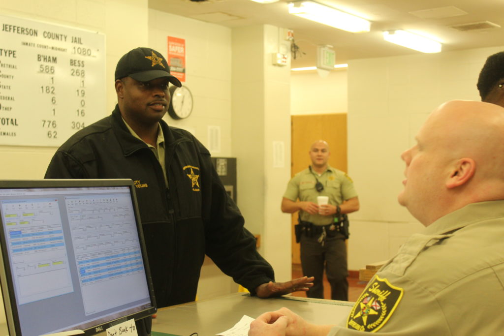 Deputy Robert Young talks with his co-workers. Sheriff Mike Hale said he wants the department to reflect the community it serves.