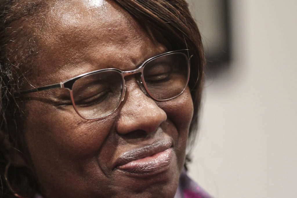Felicia Sanders, who watched her son Tywanza Sanders die at the hands of Dylann Roof, smiles while speaking to media after Roof was found guilty of murdering nine parishioners at Emanuel AME Church in Charleston in a hate crime Friday, Dec. 15, 2016, in Charleston S.C. "I wear a smile now because the nine victims wore beautiful smiles in photos before they were killed," Sanders said. (Matt Walsh, The State via AP)