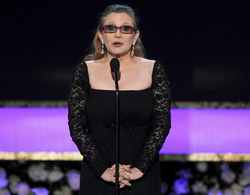 In this Sunday, Jan. 25, 2015 file photo, Carrie Fisher presents the life achievement award on stage at the 21st annual Screen Actors Guild Awards at the Shrine Auditorium in Los Angeles. (Vince Bucci/Invision/AP, File)