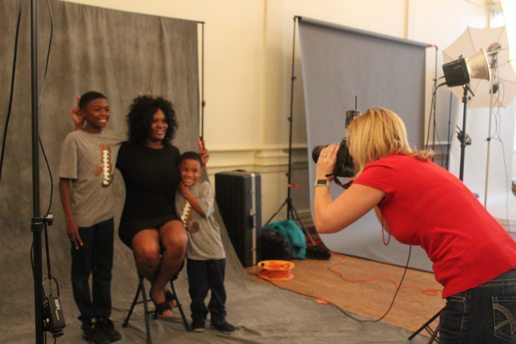 Angelle Morris and her sons Bryce and Braylon getting their photos taken by photographer Amber Ford at the YWCA Downtown for Hope Portrait Birmingham. (Provided photo)