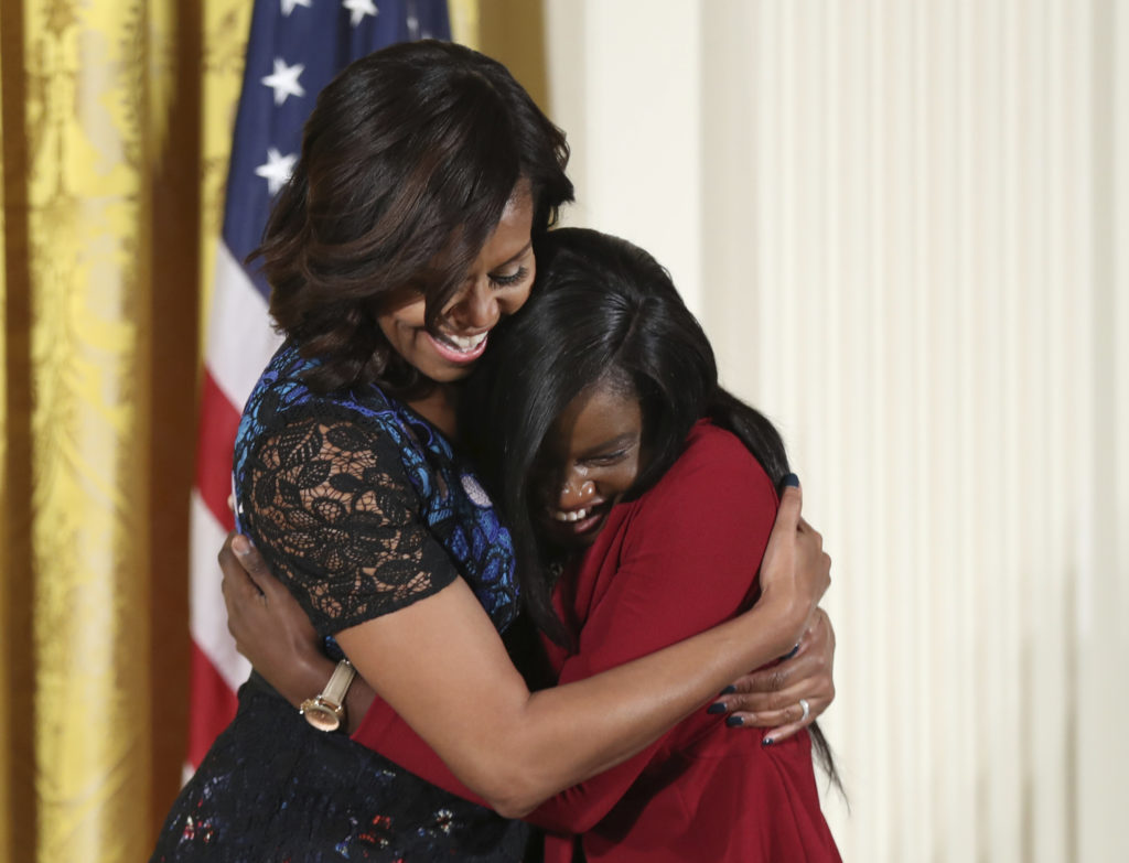 First lady Michelle Obama hugs Janasia Johnson, winner of the 2016 National Arts and Humanities Youth Program Award, during a ceremony in the East Room of the White House. (Manuel Balce Ceneta, Associated Press)