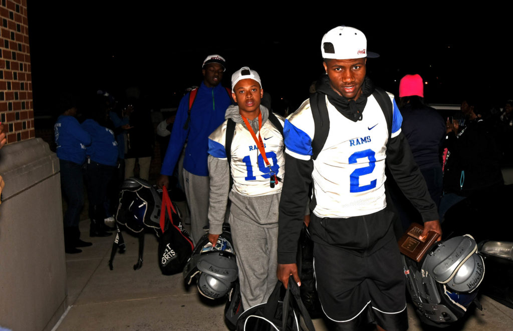 Senior quarterback Baniko Harley (2) carries his shoulder pads and his MVP trophy as he and his Ramsay teammates file into the Willie Scoggins Jr. Gymnasium after they defeated Opelika 21-16 in Jordan-Hare Stadium  to win the Class 6A Alabama High School Athletic Association state football championship on Friday, Dec. 2, 2016. (Solomon Crenshaw Jr., special to The Birmingham Times)