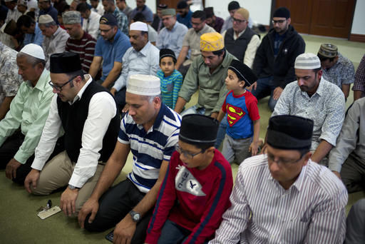 Wearing a t-shirt with a Superman logo on it, 4-year-old Atta Ul Arham attends a prayer service at the Ahmadiyya Muslim Community Mosque in Chino. (Associated Press photo)