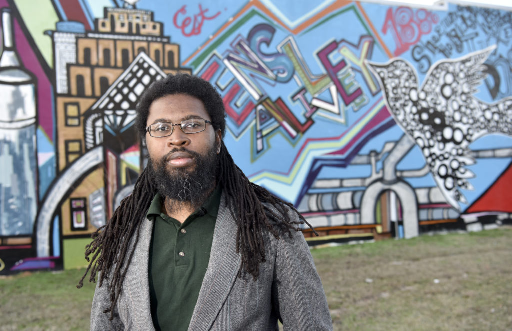 Brian Hawkins, Director of the Ensley Color Projects stands in front of the first mural in Ensley. (Frank Couch, special to The Times)
