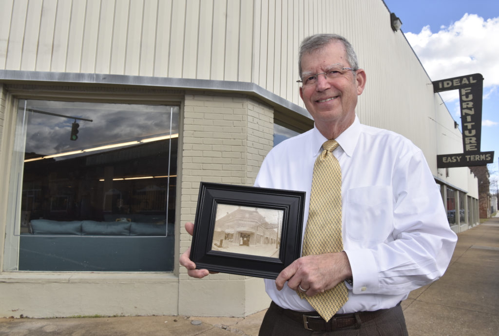 Ideal Furniture owner Melvin Zivitz holds a picture of his father's pharmacy in the same building before his father moved into the furniture business Friday January 13, 2017 . (Frank Couch, special to The Times)