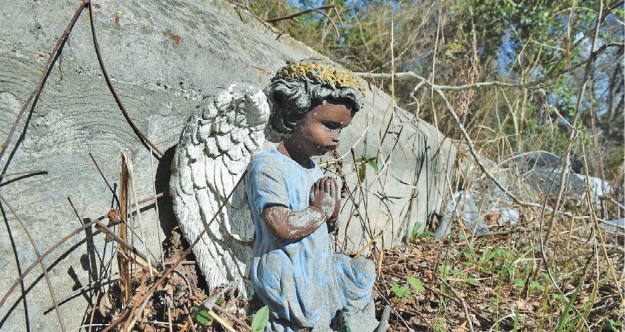 A small angel statue adorns a gravesite in the Chamberlin cemetery. (Provided photo)