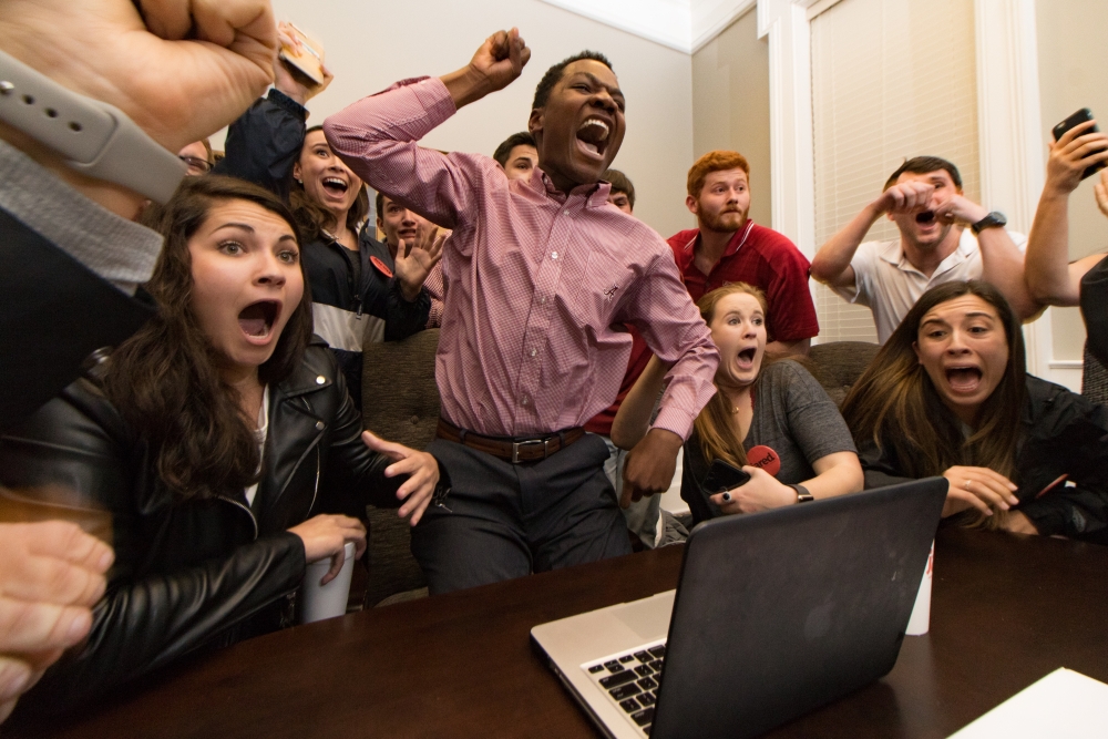 Jared Hunter, center, and his campaign staff react to his election as student body president at the University of Alabama in Tuscaloosa, Ala., on Tuesday, March 7, 2017. Originally from Wetumpka, Ala., Hunter is the first black student to win the position with the backing of a secretive group called The Machine, which is composed of the school's most prestigious, historically white fraternities and sororities (Jacob Arthur/Alabama Crimson White via AP)