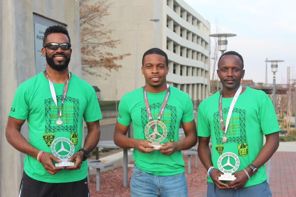 rom left: Eric Thomas, Walter McCord and Gideon Waithera holding their trophies from the Mercedes Marathon. (Ariel Worthy, The Birmingham Times)